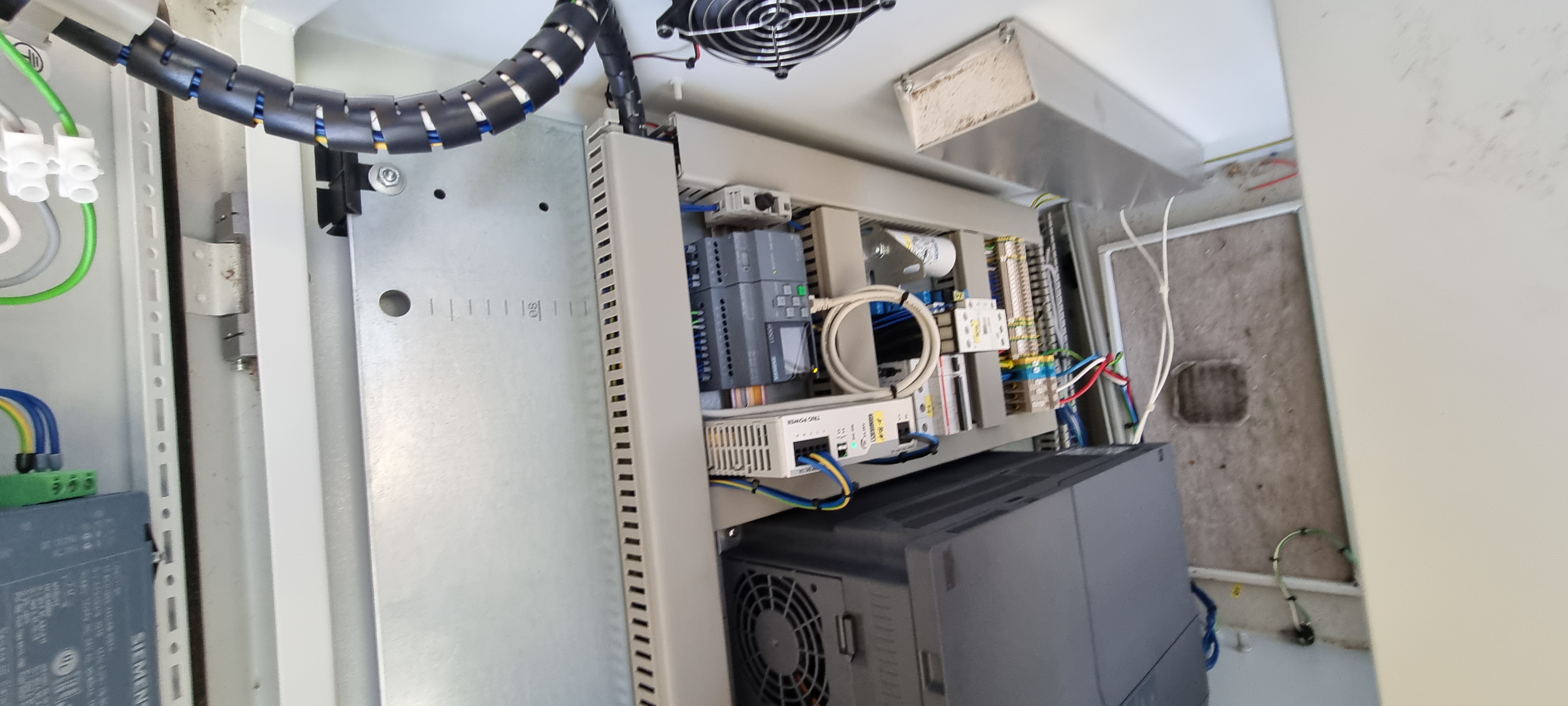 Internal cabinet showing Siemens LOGO PLC, power supply and DIN-rail terminals beside the Mitsubishi VSD